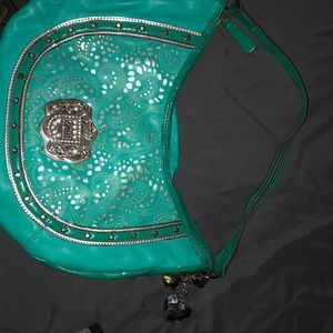 Kathy van zeeland turquoise bag with silver accents and a second strap inside